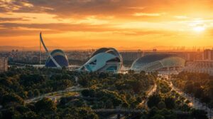 Wide golden-hour skyline shot of Valencia looking across the Turia Gardens toward the City of Arts and Sciences,