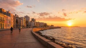 Wide golden-hour shot of the Montevideo Rambla coastal promenade, the Rio de la Plata stretching to the horizon on one side